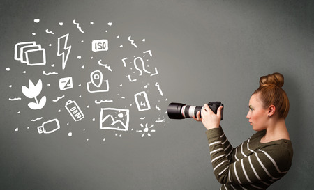 Young photographer girl capturing white photography icons and symbolsの写真素材