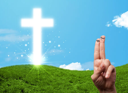 Happy finger smiley faces on hand with christian religion crossの写真素材