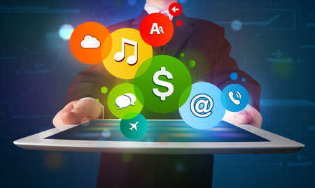 Young businessman presenting colorful modern signs