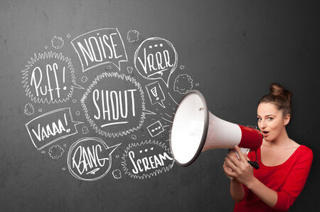 Pretty girl yelling into megaphone and hand drawn speech bubbles come out の写真素材