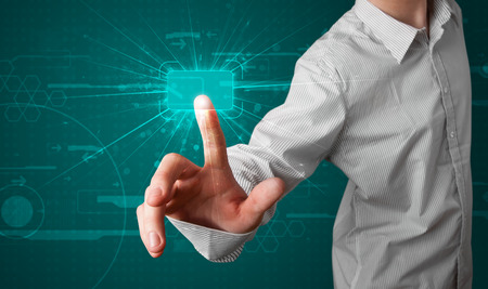 Young businessman pressing high tech type of modern buttonsの写真素材