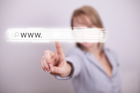 Young woman touching web browser address bar with www signの写真素材