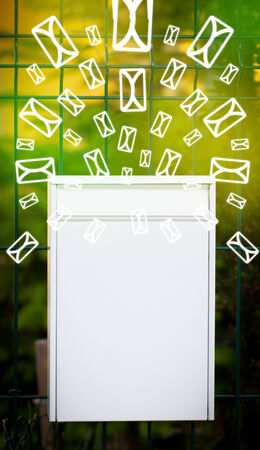 Mailbox with letter icons exploding on glowing green backgroundの写真素材