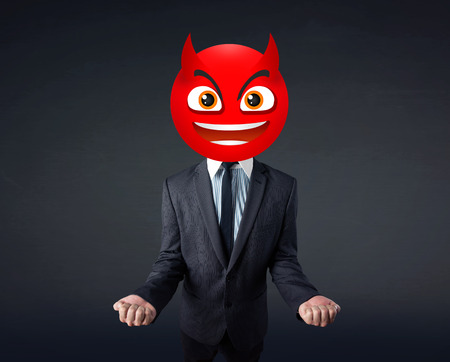 Funny businessman wears devil smiley faceの写真素材