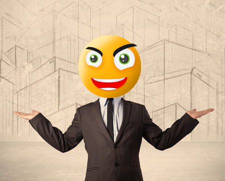 Funny businessman with yellow smiley faceの写真素材