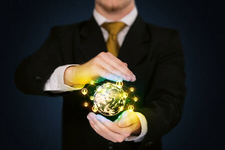 Businessman holding a shining globe with social media connectionの写真素材
