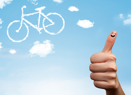 Happy cheerful smiley fingers looking at a bicycle shapeed cloudの写真素材