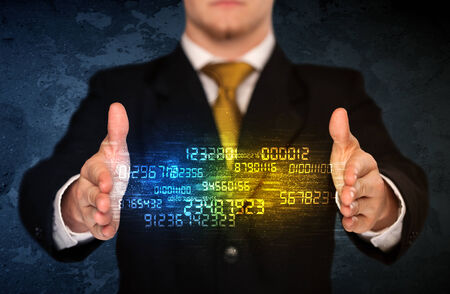 Businessman holding a shining number cloud in front of his bodyの写真素材