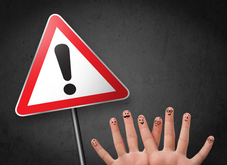Happy cheerful smiley fingers looking at triangle warning sign with exclamation markの写真素材