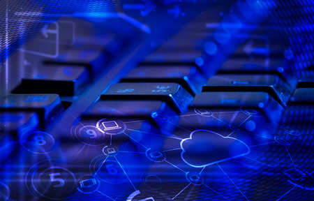 Computer keyboard with glowing cloud computing and multimedia icons