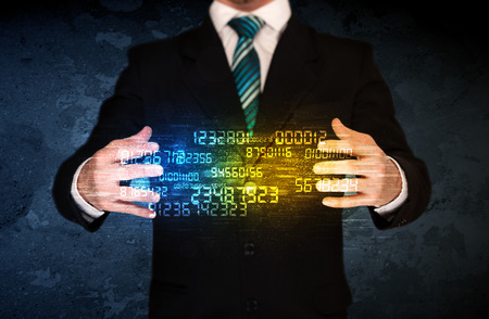 Businessman holding a shining number cloud in front of his bodyの写真素材