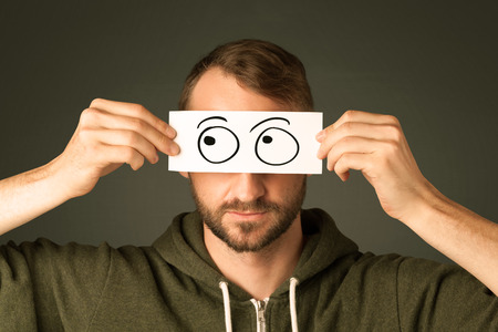 Silly man looking with hand drawn eye balls on paper