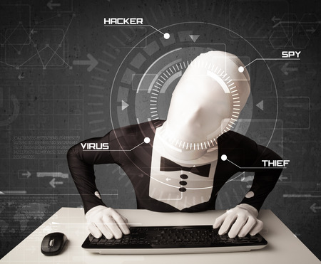 Hacker without identity in futuristic enviroment hacking personal information on tech backgroundの写真素材