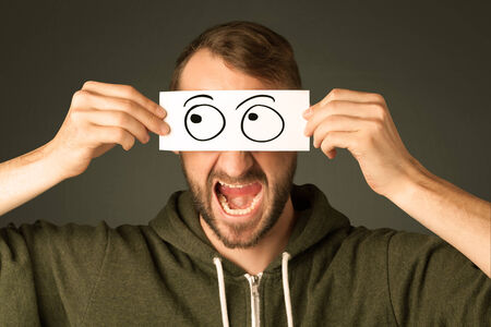 Silly man looking with hand drawn eye balls on paperの写真素材