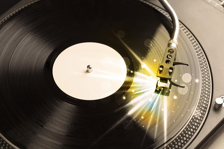 Music player playing vinyl with glow lines coming from the needle concept 