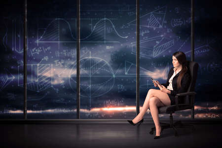 Businesswoman holding tablet in office room with graph charts on window concept