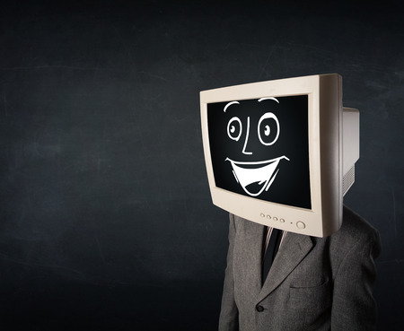 Happy businessman with a personal computer monitor head and a smiley face