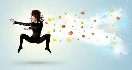 Beautiful woman jumping with colorful gems and crystals on the background concept