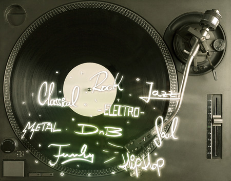 Turntable with vinyl and music genres writen concept on background