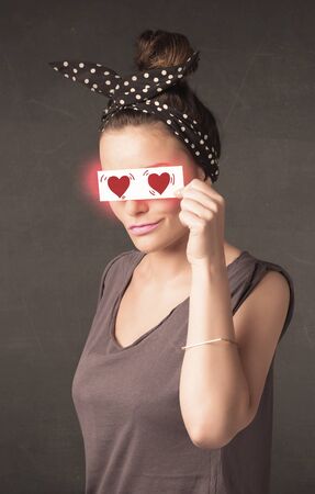 Pretty girl holding paper with red heart drawing conceptの写真素材