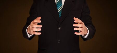 Businessman holding something in front of his bodyの写真素材