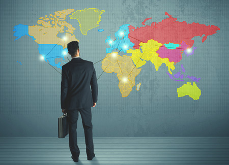 Young businessman drawing map on wall, social network conceptの写真素材