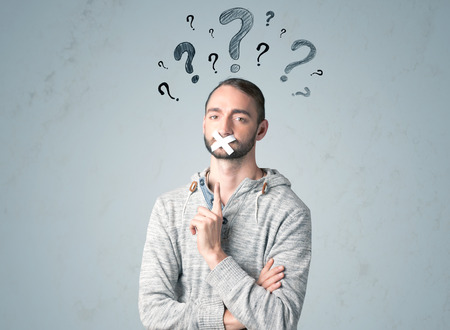 Young man with taped mouth and question mark symbols around his head