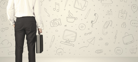 Businessman from the back in front of an social media icon wallの写真素材