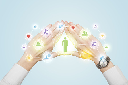 Hands creating a form with social media connection in the centerの写真素材