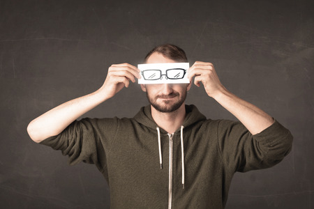 Happy guy looking with paper hand drawn eye glasses conceptの写真素材