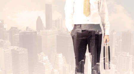 Handsome business man with overlay cityscape backgroundの写真素材