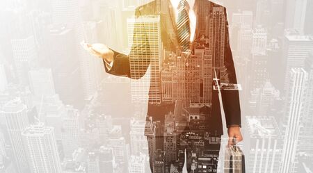 Business man with warm color overlay of city background textureの写真素材