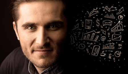 A successful confident businessman near graph pie charts and calculations conceptの写真素材