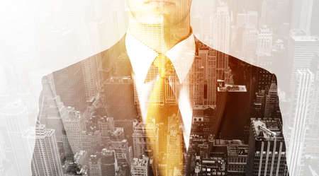 Business man with warm color overlay of city background textureの写真素材