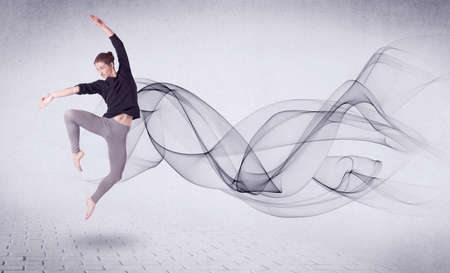 Modern ballet dancer performing with abstract swirl concept on backgroundの写真素材