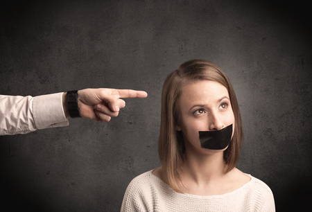 Caucasian business hand pointing at female employee with grunge backgroundの写真素材