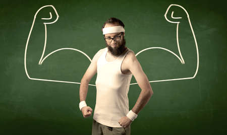 A young man with beard and glasses posing in front of green background, imagining how he would look like with big muscles, illustrated by minimalist white drawing concept.の写真素材