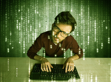 A talented hacker scanning online passwords database and hacking emails of users with numbers, codes, letters running in the background conceptの写真素材