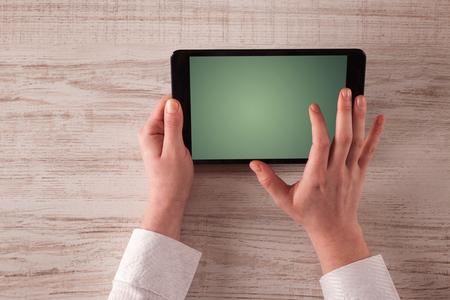 Caucasian business hands holding and working on plain tabletの写真素材