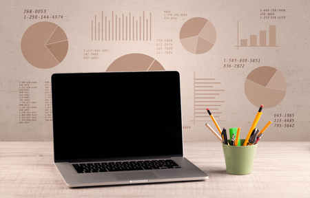 Graphic business office desk with pie charts and graphs on the brown sepia background wallの写真素材