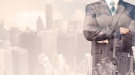 Handsome business man with overlay cityscape backgroundの写真素材