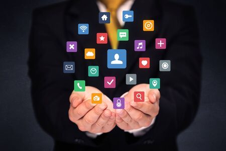 Colorful multimedia icons in the hands of a businessmanの写真素材