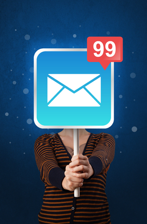 Casual young woman holding square sign with mail iconの写真素材