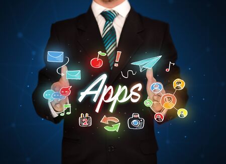 Businessman with drawn application icons and symbols in his handsの写真素材