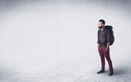 Standing handsome young man with a backpackの写真素材