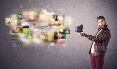 A funny stylish hipster guy capturing moments and memories with a retro photo camera illustration conceptの写真素材