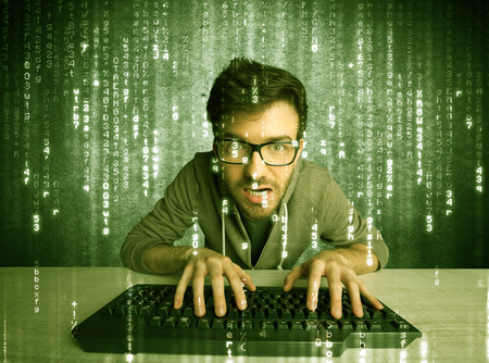 A talented hacker scanning online passwords database and hacking emails of users with numbers, codes, letters running in the background conceptの写真素材