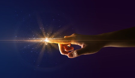 Female finger touching a beam of light