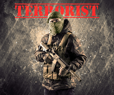 Portrait of dangerous masked and armed man with terrorist sign on grungy background