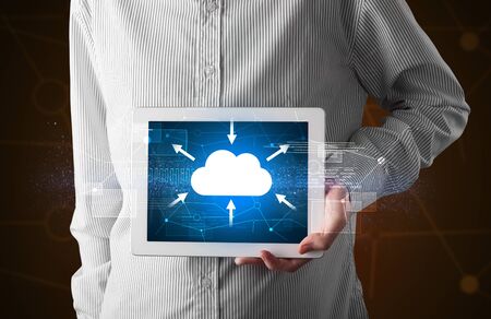 Casual businessman holding tablet with cloud conceptの写真素材